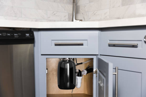 Installed garbage disposal unit under a modern kitchen sink