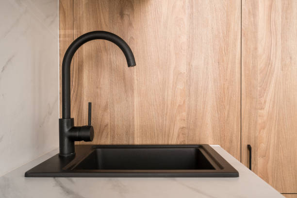 Modern black bar sink with a sleek design installed in the counter